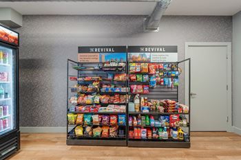 A vending machine selling snacks and drinks in a room.